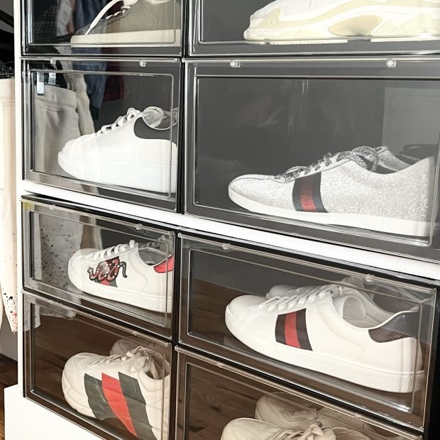 Designer sneakers in clear drop-front boxes stacked two wide