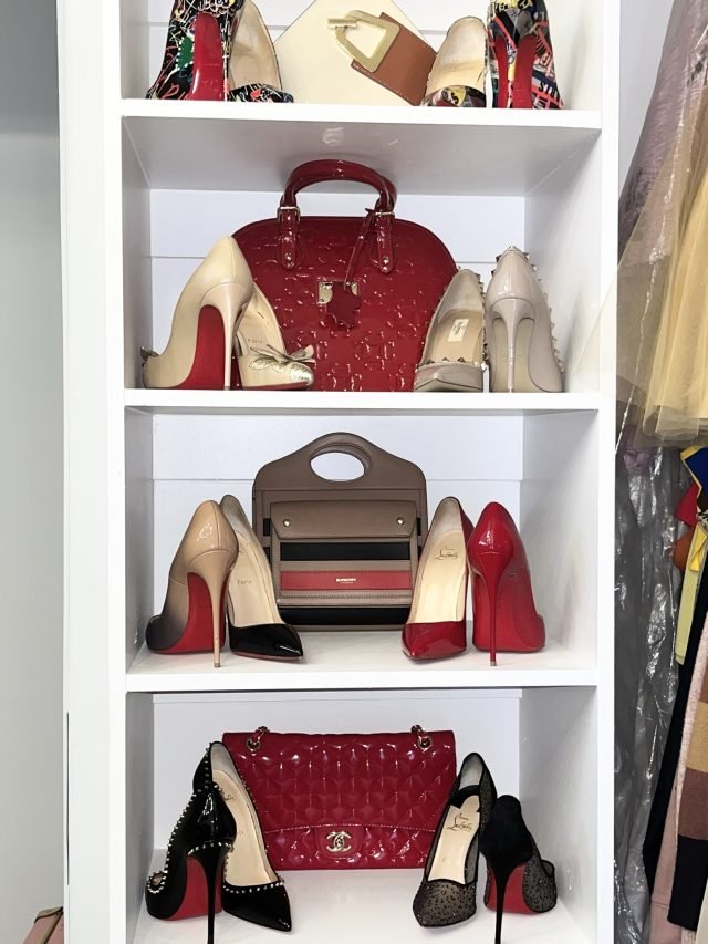 Designer heels and handbags displayed on white shelving