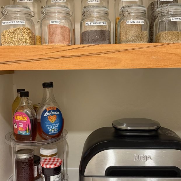 Kitchen spices decanted into labeled glass jars after a full home unpack