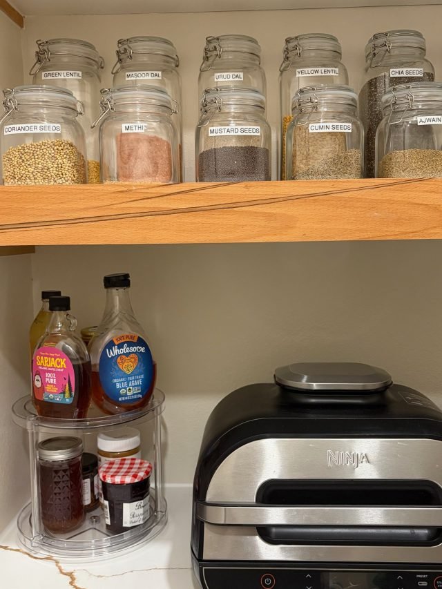 Kitchen spices decanted into labeled glass jars after a full home unpack
