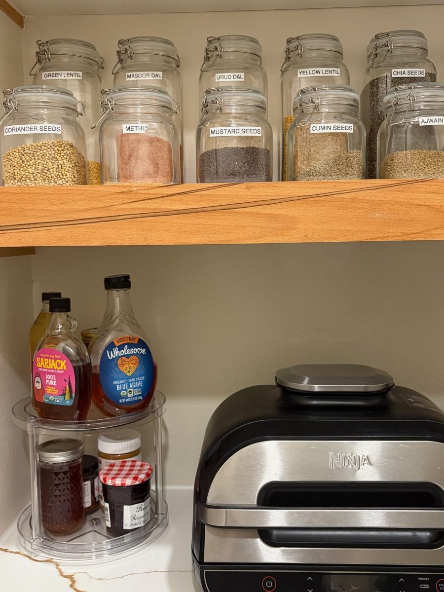 Kitchen spices decanted into labeled glass jars after a full home unpack