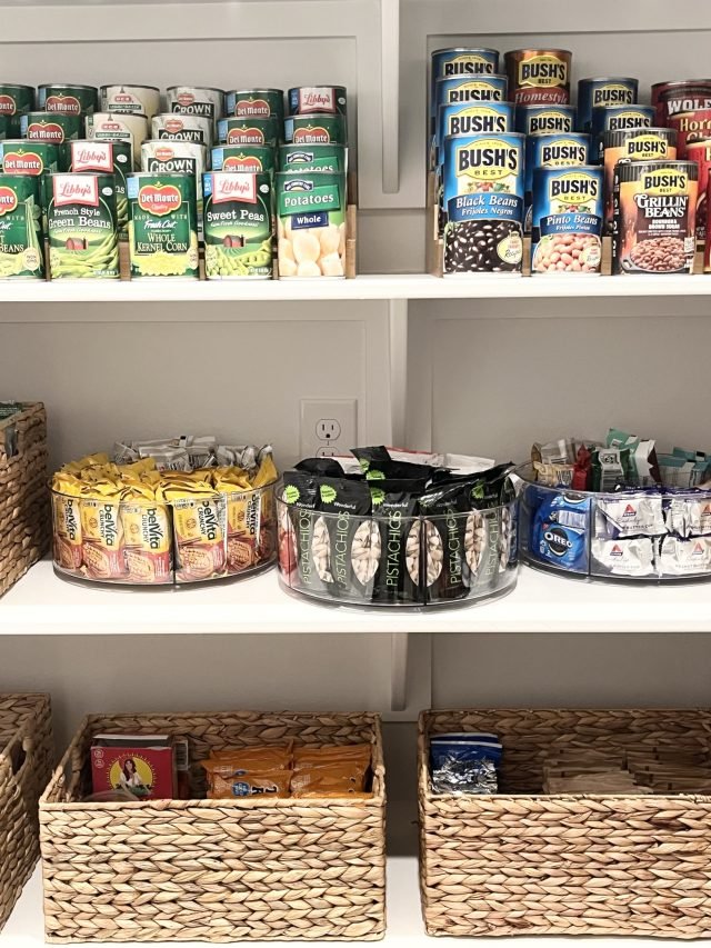 Canned goods and chips shelved above two woven baskets on a lower shelf