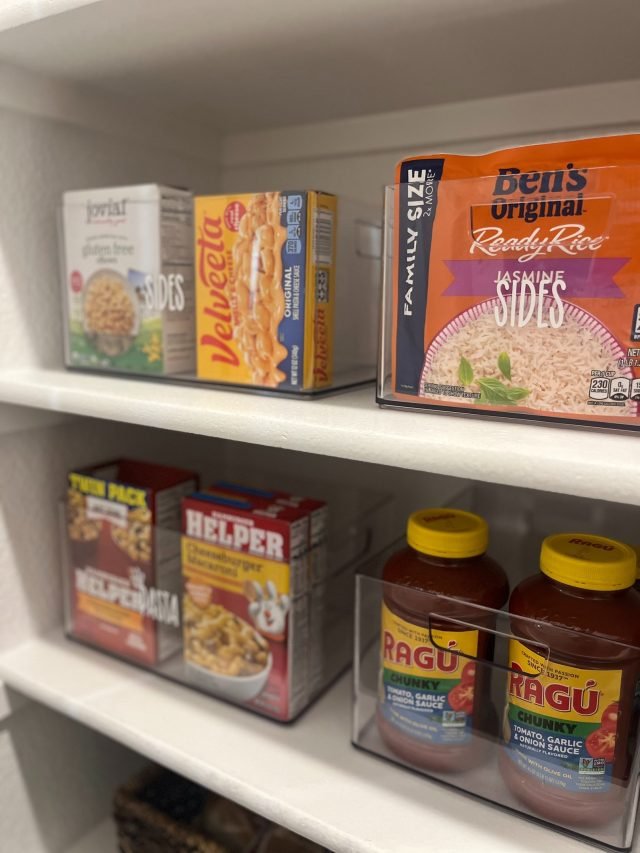 Pantry organized with labeled acrylic containers after a Plano relocation unpack