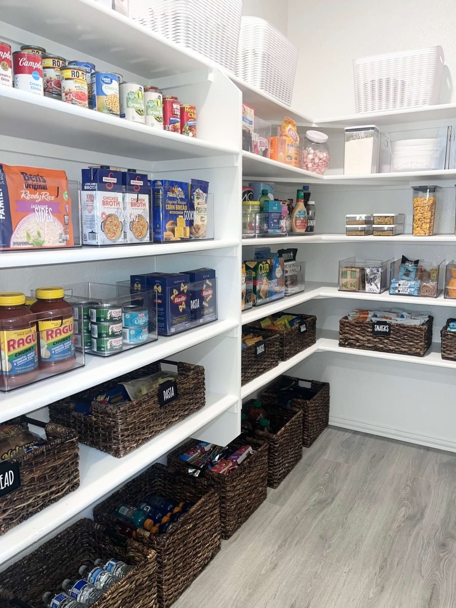 Pantry shelves reset with wicker baskets and clear labels during a maintenance visit
