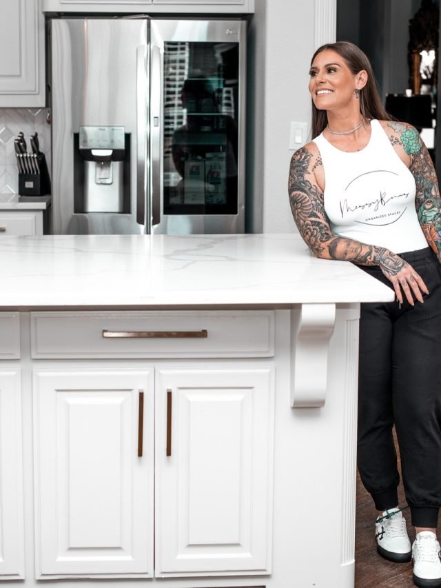 Ashley Matteson carrying a woven basket through a client's kitchen